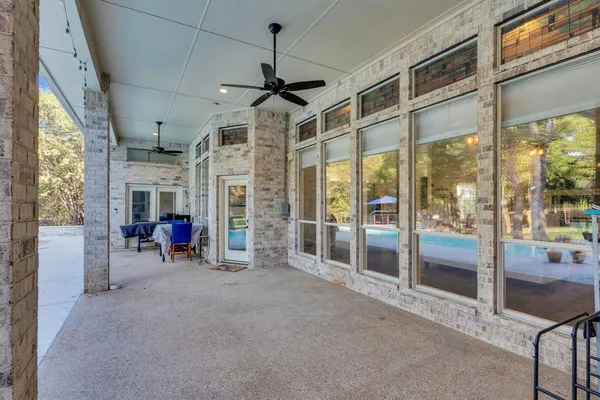 a view of a livingroom with fireplace furniture and windows