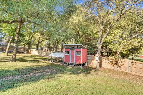 a sign board with tall trees