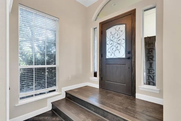 a view of an entryway with wooden floor