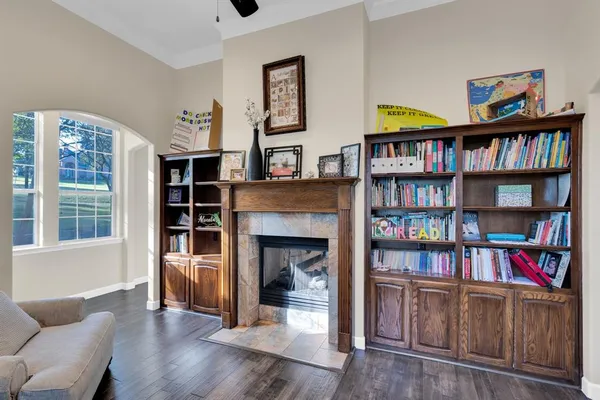 a living room with furniture and a book shelf