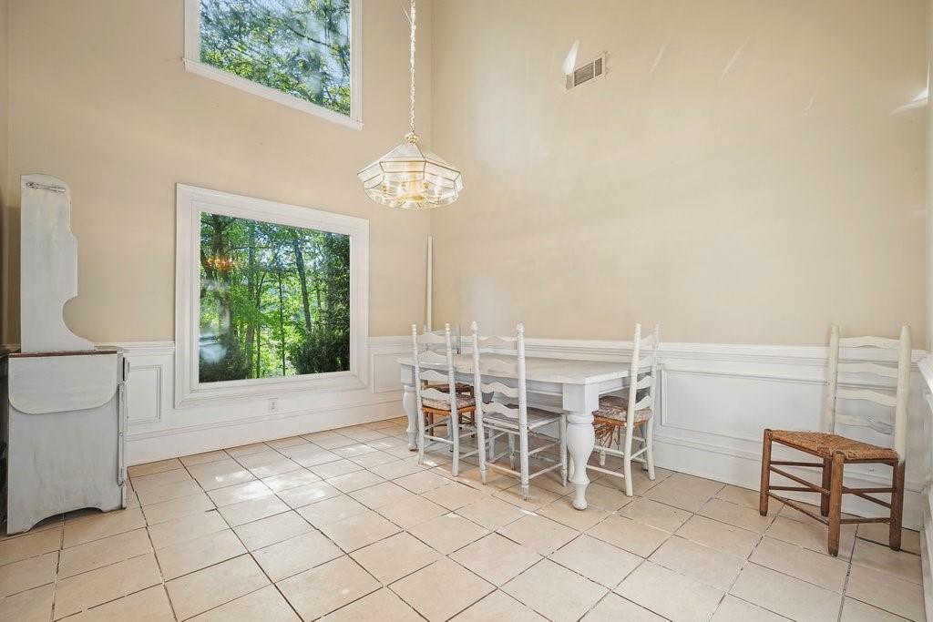 1513 Old Jones Road Alpharetta, GA 30004 - Photo 11 of 62 a view of a dining room with furniture and chandelier
