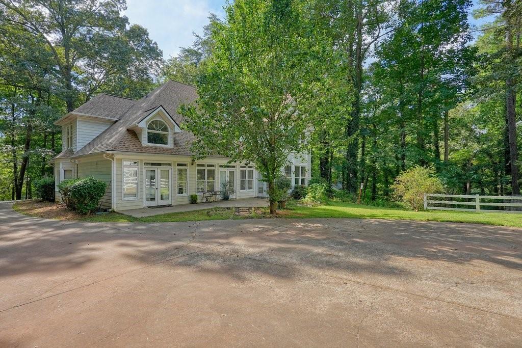 1513 Old Jones Road Alpharetta, GA 30004 - Photo 20 of 62 a front view of a house with a yard and trees