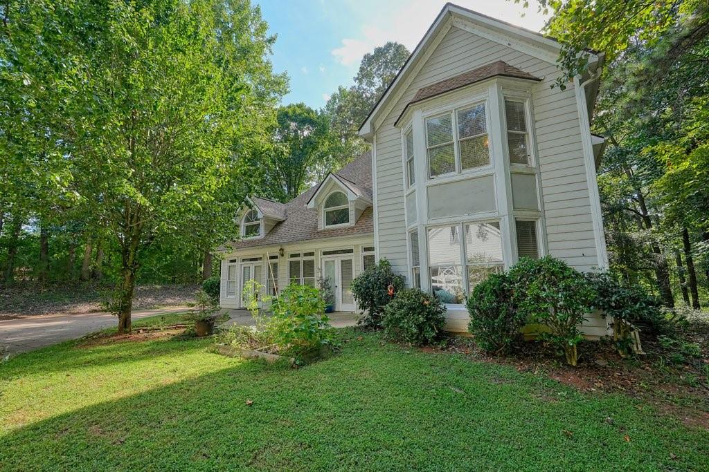 1513 Old Jones Road Alpharetta, GA 30004 - Photo 2 of 62 a front view of a house with a yard