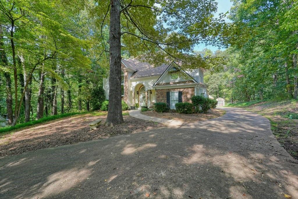 1513 Old Jones Road Alpharetta, GA 30004 - Photo 27 of 62 a front view of a house with a yard and garage
