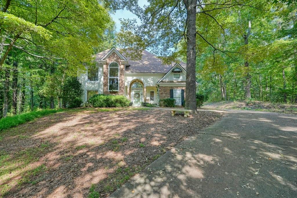 1513 Old Jones Road Alpharetta, GA 30004 - Photo 30 of 62 a front view of a house with a garden