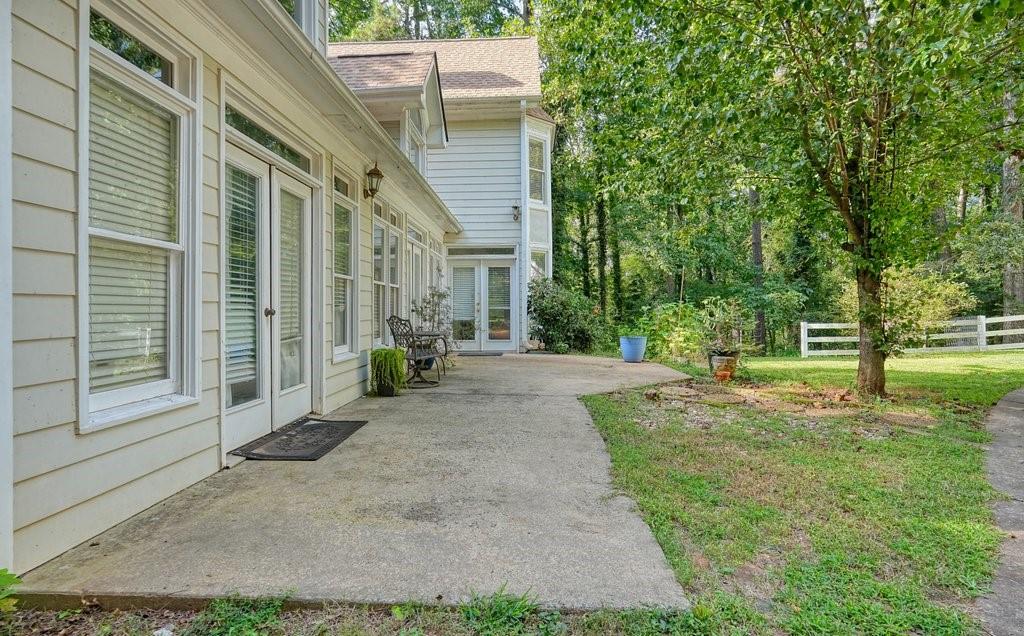 1513 Old Jones Road Alpharetta, GA 30004 - Photo 3 of 62 a view of a house with backyard and a tree
