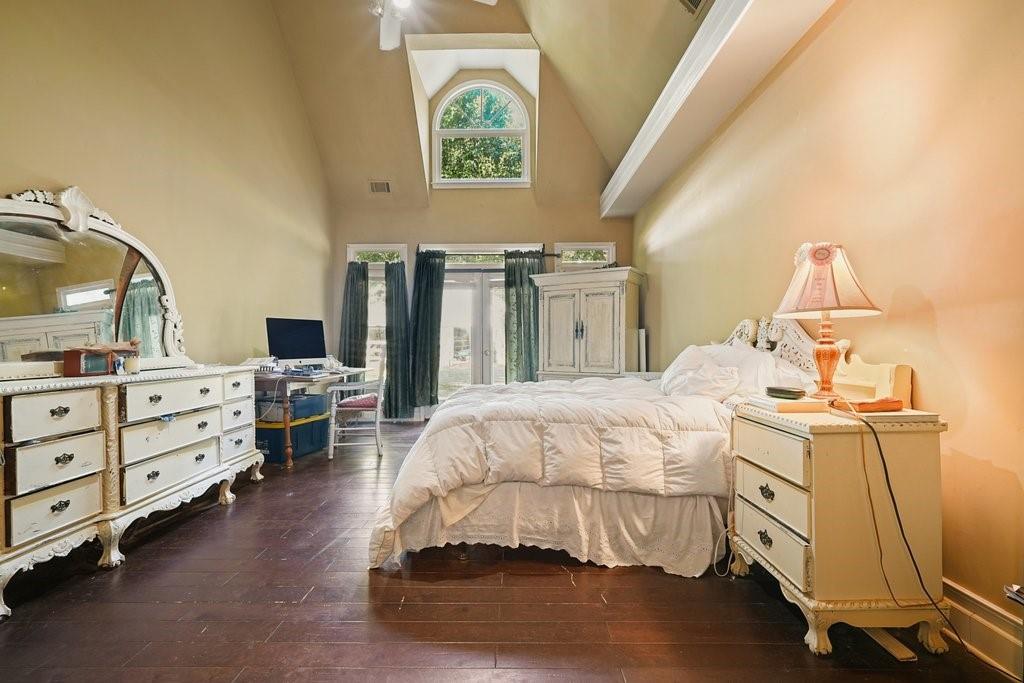 1513 Old Jones Road Alpharetta, GA 30004 - Photo 35 of 62 a bedroom with a bed and a chandelier