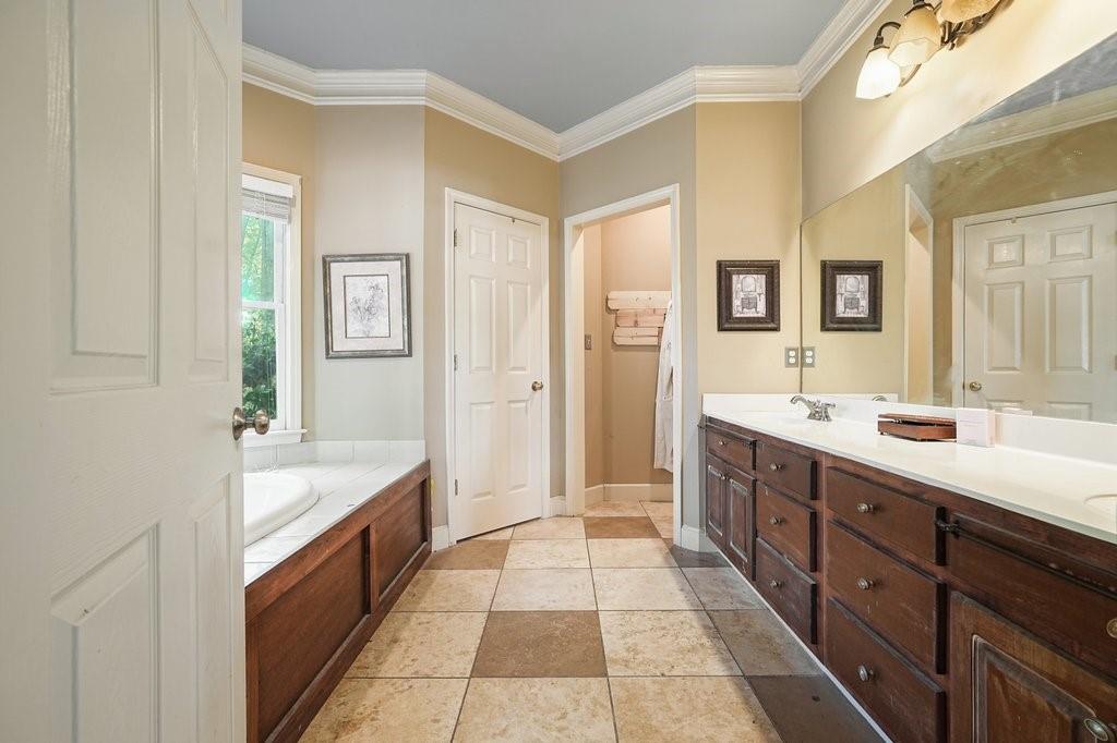 1513 Old Jones Road Alpharetta, GA 30004 - Photo 36 of 62 a spacious bathroom with a double vanity sink a mirror and a bathtub