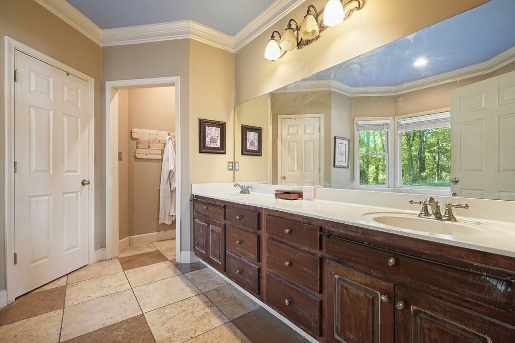 1513 Old Jones Road Alpharetta, GA 30004 - Photo 37 of 62 a spacious bathroom with a double vanity sink a mirror and a shower