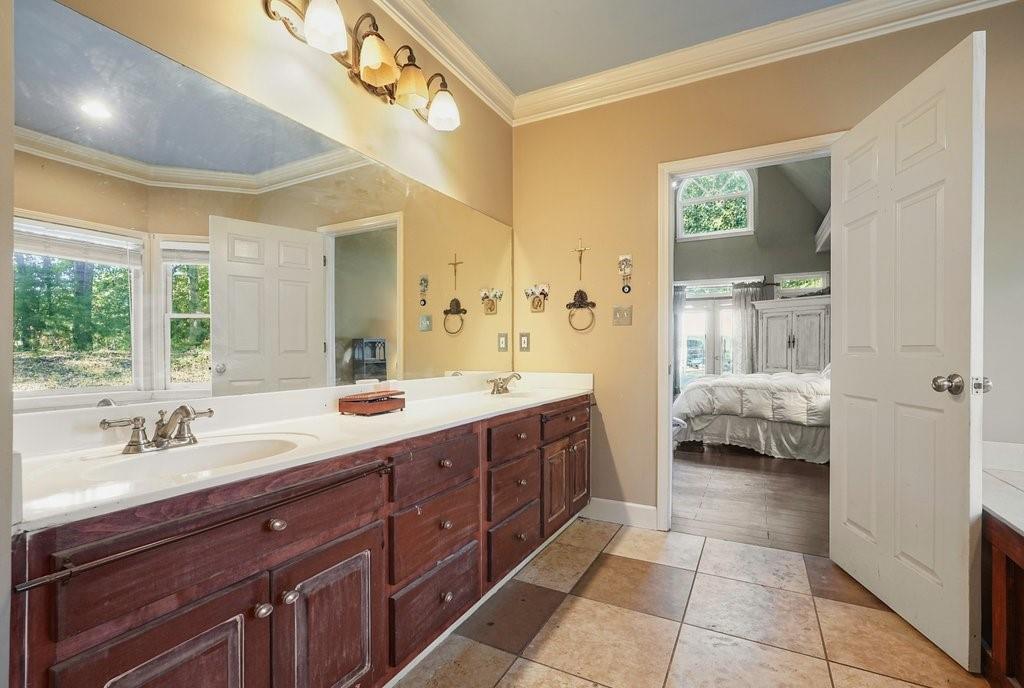 1513 Old Jones Road Alpharetta, GA 30004 - Photo 38 of 62 a spacious bathroom with a tub sink and mirror