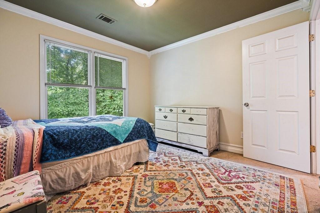 1513 Old Jones Road Alpharetta, GA 30004 - Photo 47 of 62 a bedroom with a bed and a dresser