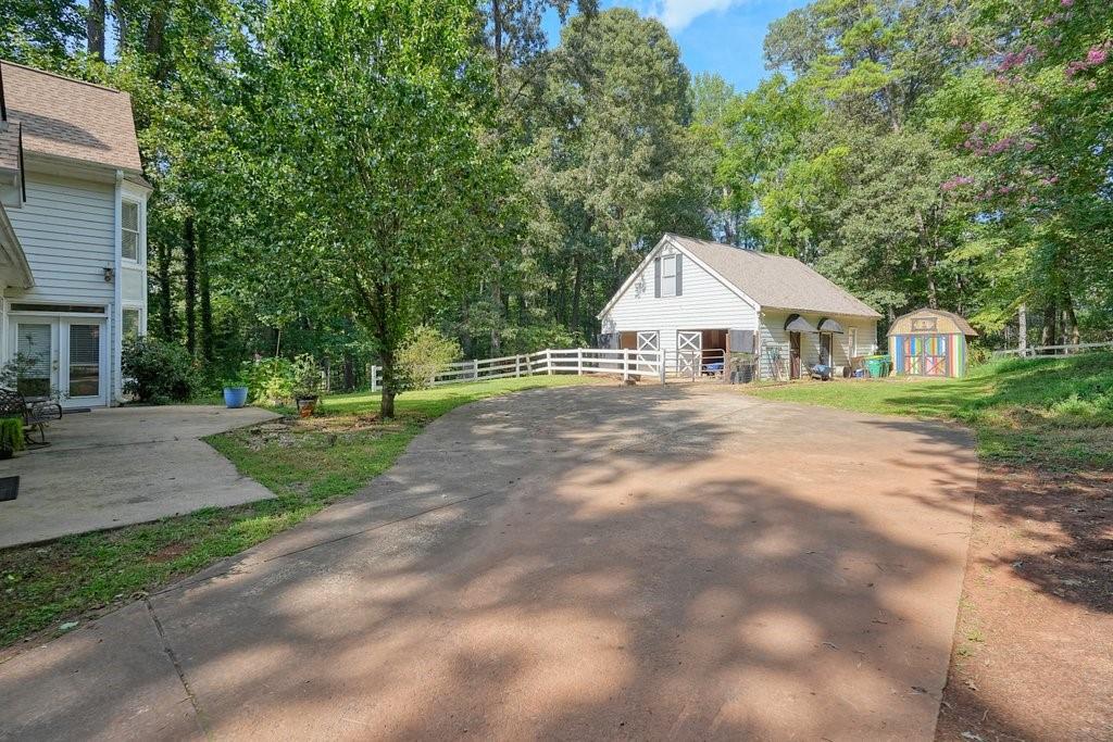 1513 Old Jones Road Alpharetta, GA 30004 - Photo 52 of 62 a front view of a house with a yard and trees