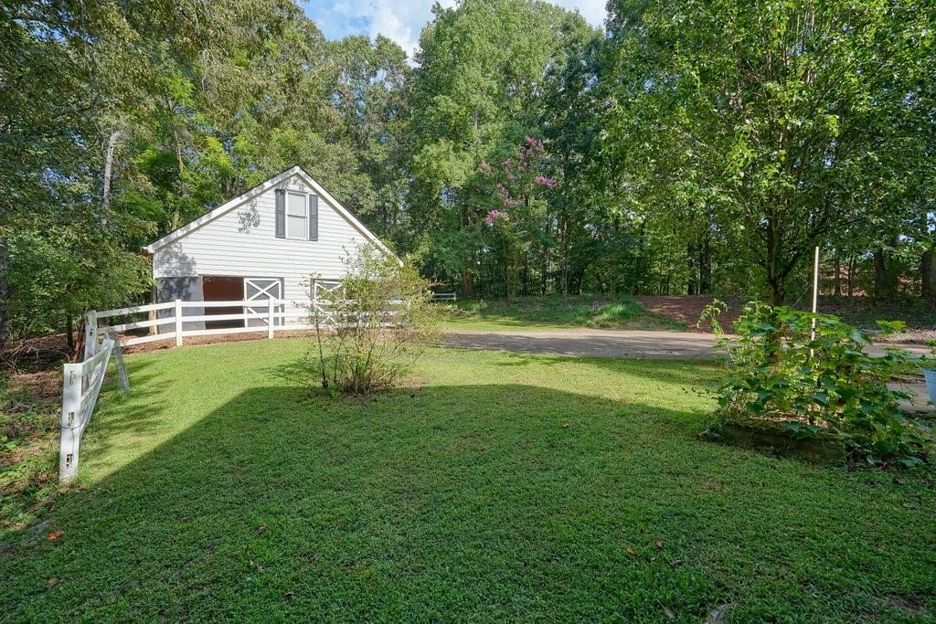 1513 Old Jones Road Alpharetta, GA 30004 - Photo 53 of 62 a view of a house with a backyard and a tree