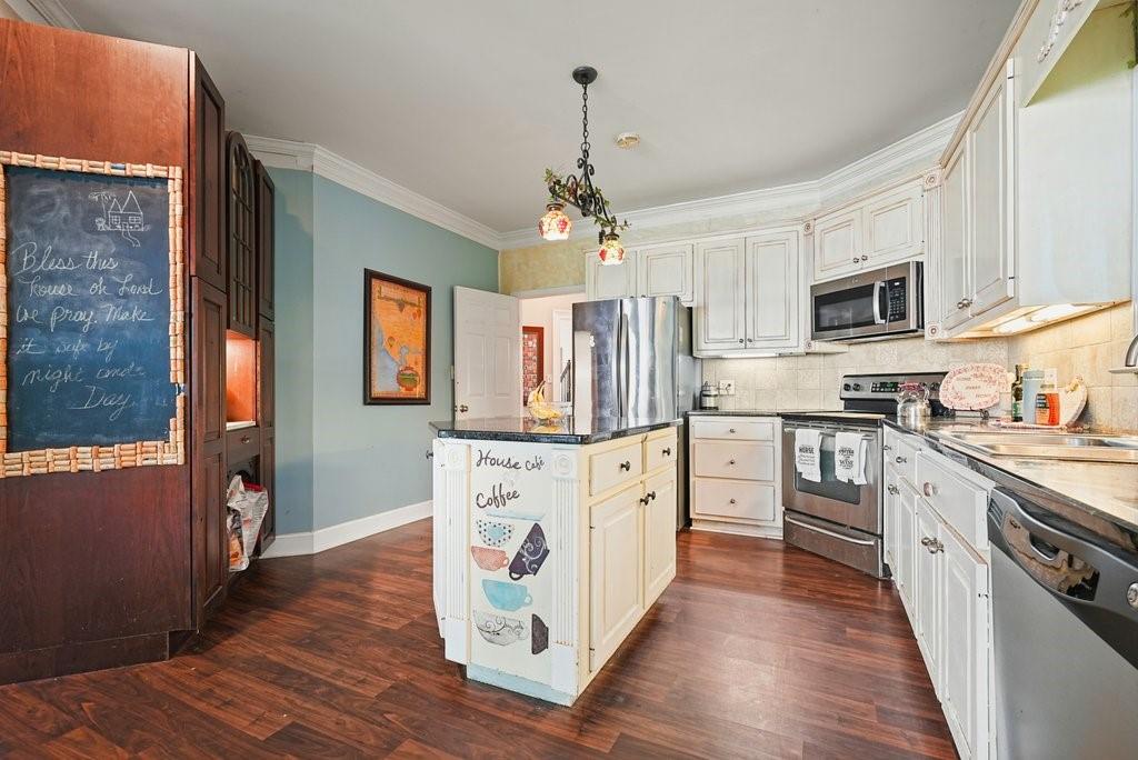 1513 Old Jones Road Alpharetta, GA 30004 - Photo 6 of 62 a kitchen with stainless steel appliances granite countertop a refrigerator a stove top oven a sink and dishwasher with wooden floor