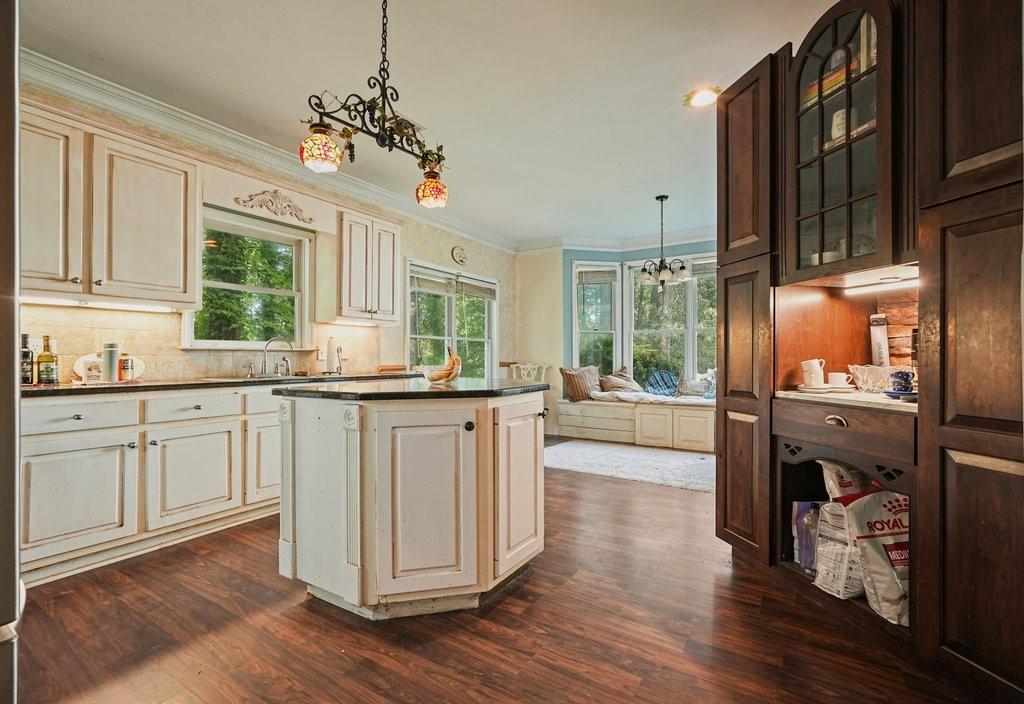 1513 Old Jones Road Alpharetta, GA 30004 - Photo 9 of 62 a kitchen with sink cabinets and wooden floor