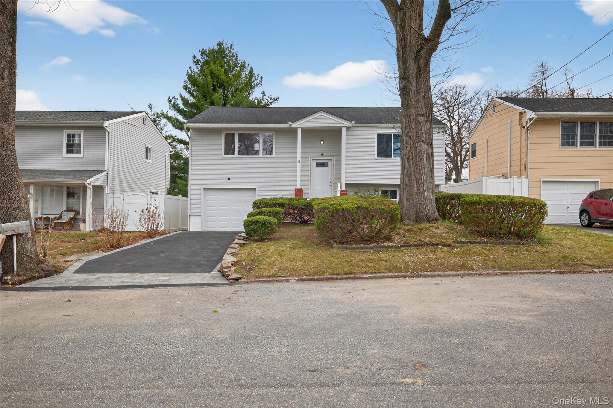 15 Lindsay Street Huntington, NY 11743 - Photo 1 of 23 a front view of a house with a yard and garage