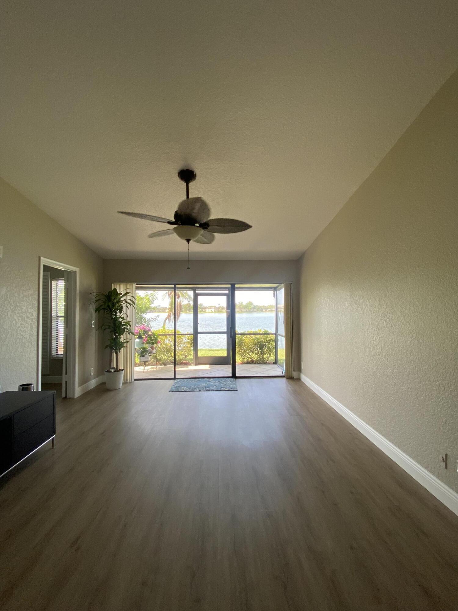 595 Banks Road Margate, FL 33063 - Photo 12 of 35 an empty room with wooden floor and windows