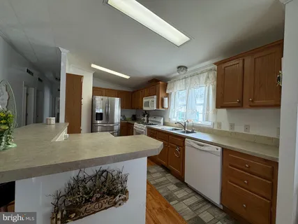 a kitchen with a sink a stove and cabinets