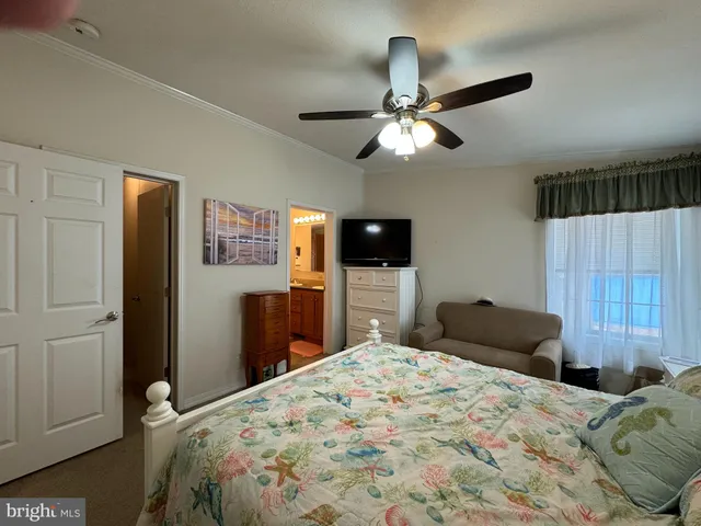 a bedroom with a bed and a tv