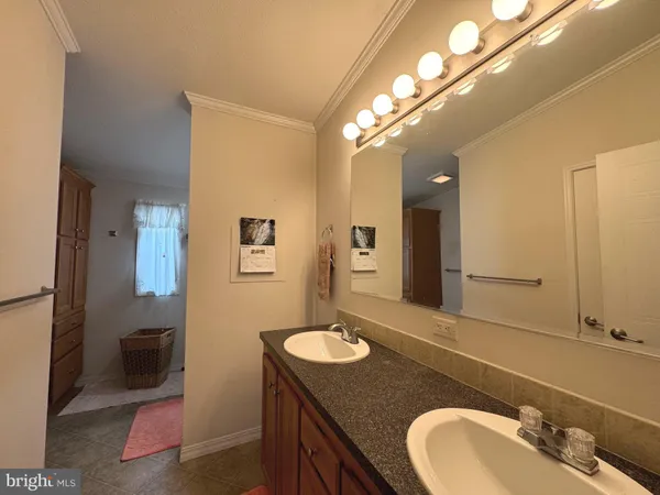 a bathroom with a granite countertop sink a mirror and a toilet