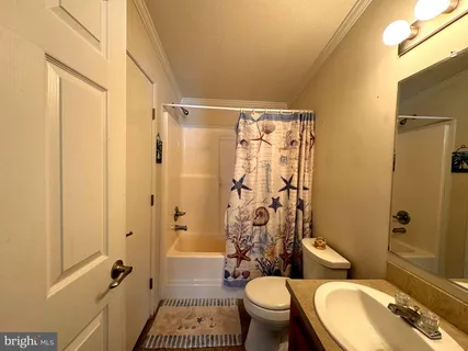 a bathroom with a granite countertop toilet sink and shower