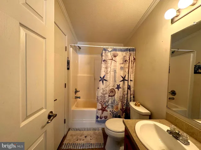a bathroom with a granite countertop toilet sink and shower