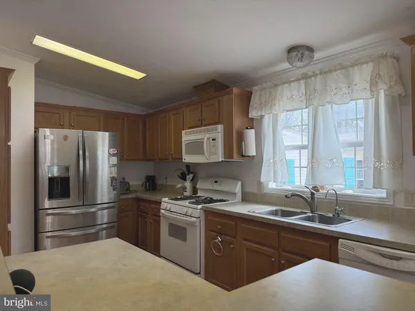 a kitchen with a sink stainless steel appliances and cabinets