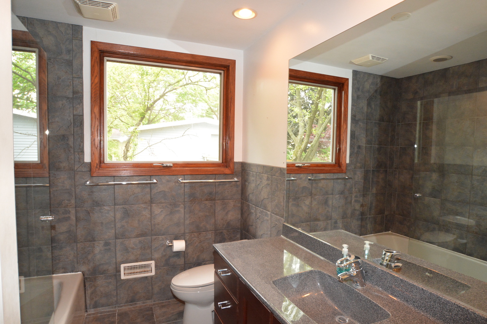 346 Park Place Glencoe, IL 60022 - Photo 14 of 15 a bathroom with a granite countertop toilet a sink and a shower