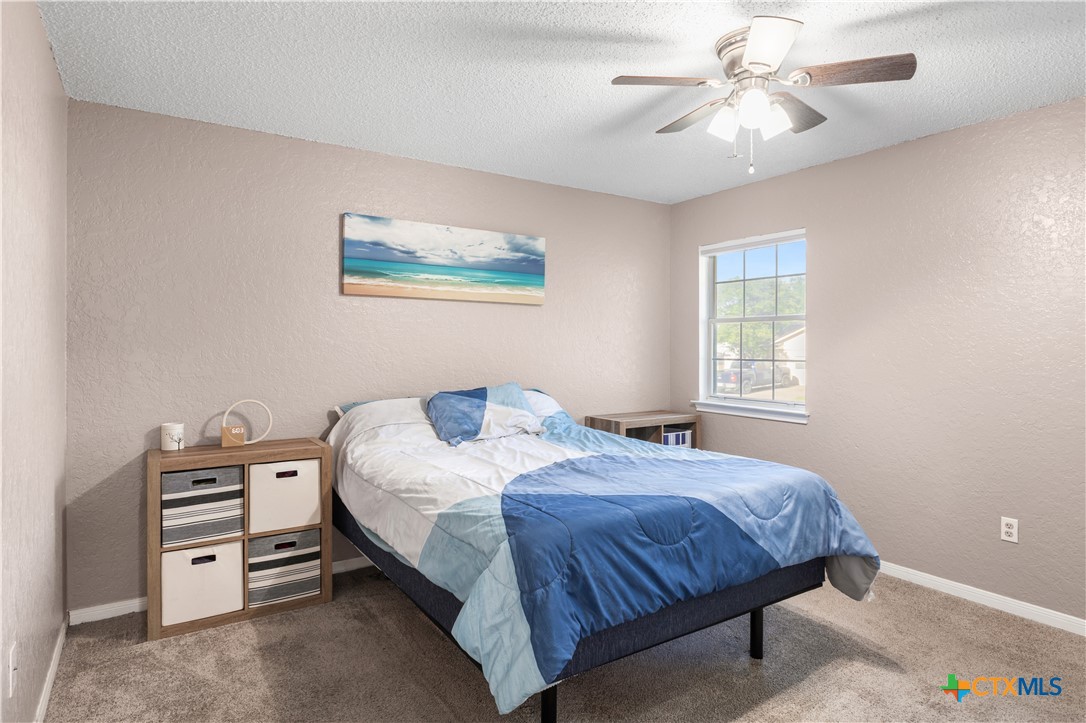 144 Jordan Loop Nolanville, TX 76559 - Photo 5 of 20 a bedroom with a bed and a chandelier