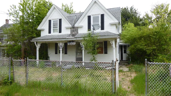 a front view of a house with a garden