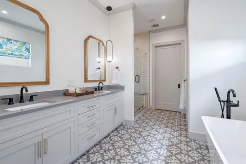 a bathroom with a double vanity sink and a mirror