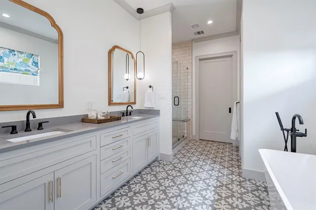 a bathroom with a double vanity sink and a mirror