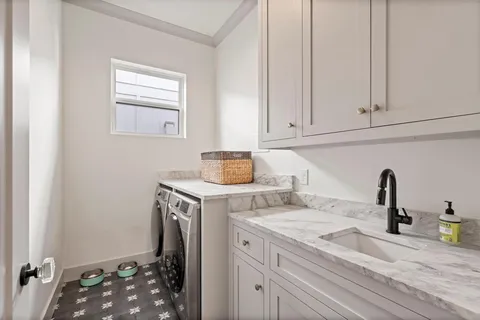 a room with a sink and cabinets