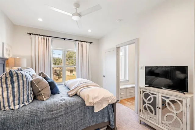 a bedroom with a large bed and a flat screen tv