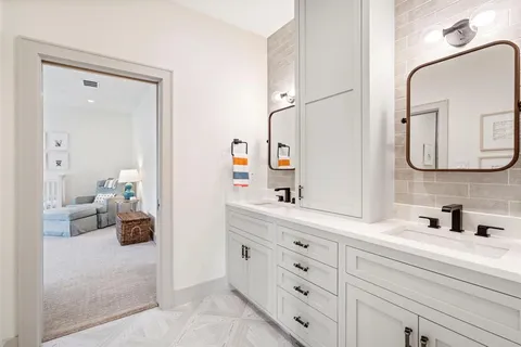 a bathroom with a double vanity sink and a mirror