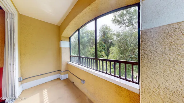 a view of a balcony with wooden floor