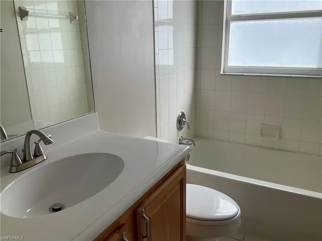 a bathroom with a sink a toilet and bathtub