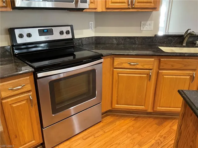 a stove top oven sitting inside of a kitchen