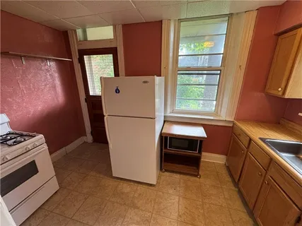 a kitchen with a refrigerator and a stove