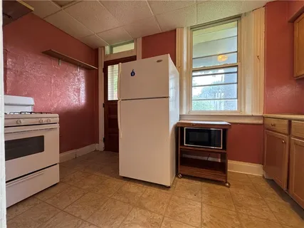 a kitchen with granite countertop a refrigerator and a stove