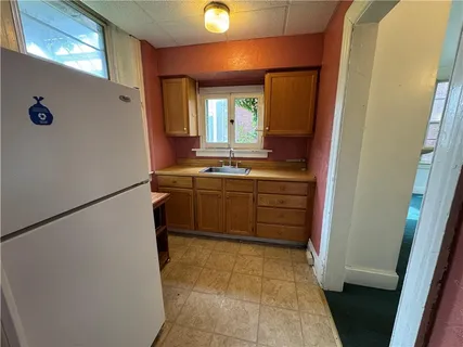 a kitchen with a sink stove and cabinets