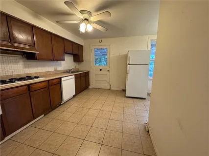 a kitchen with stainless steel appliances granite countertop a sink a stove top oven and cabinets