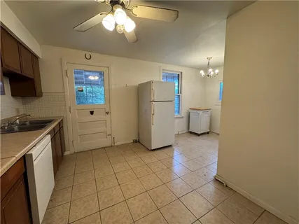 a kitchen with a refrigerator and a stove top oven