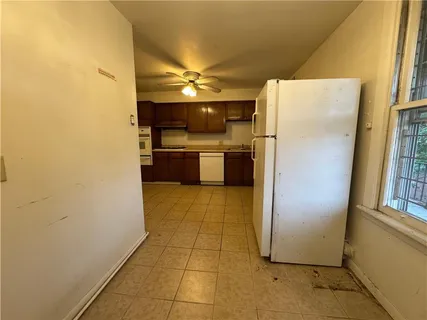 a kitchen with a refrigerator and a stove