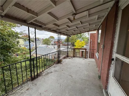an empty room with windows and sink