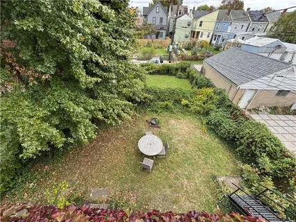 a backyard of a house with table and chairs