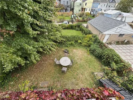 a view of a chairs and table in backyard of the house