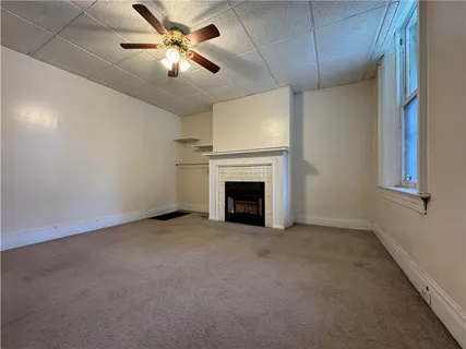 a view of an empty room with a fireplace