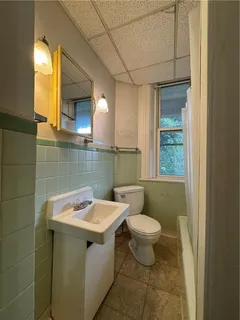 a bathroom with a sink toilet and window