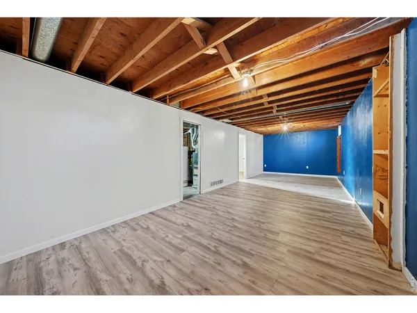 a view of empty room with wooden floor